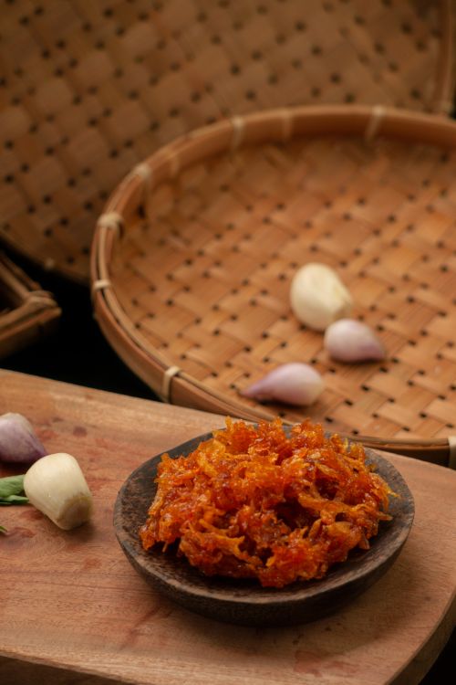 Free Authentic Indonesian sambal served on a wooden platter with shallots and garlic. Stock Photo