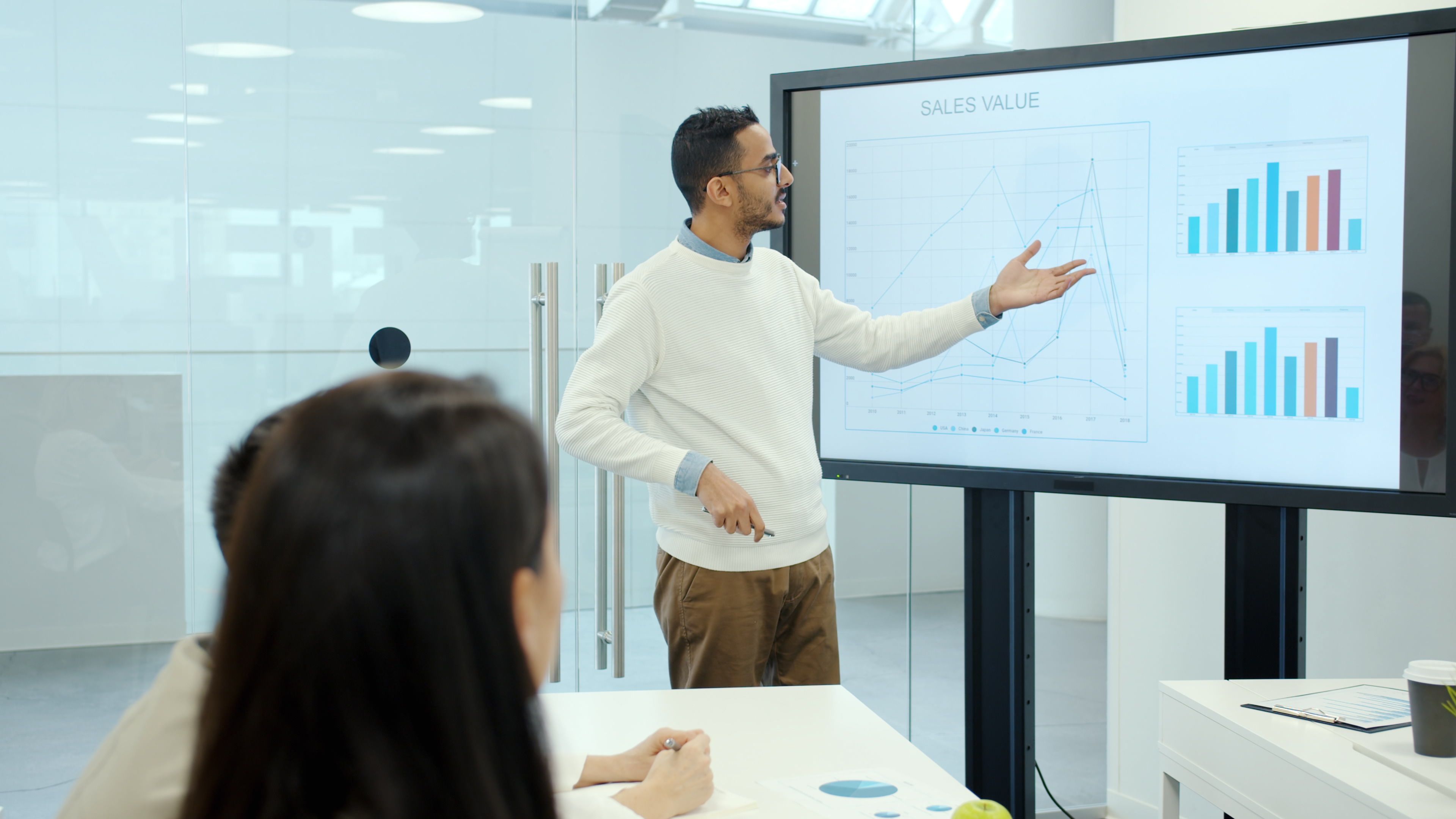 Professional presentation with graphs in a modern office environment.