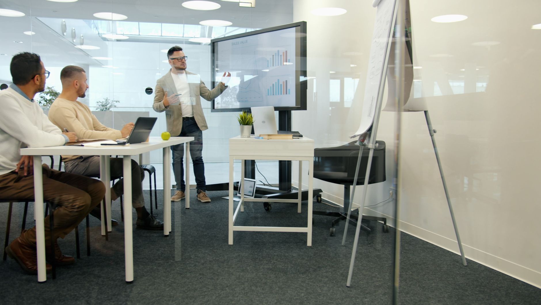 Analysts presenting predictive data dashboards in a modern office