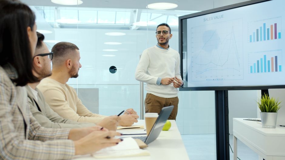 Marketing agency team reviewing keyword ranking difficulty scores on a laptop