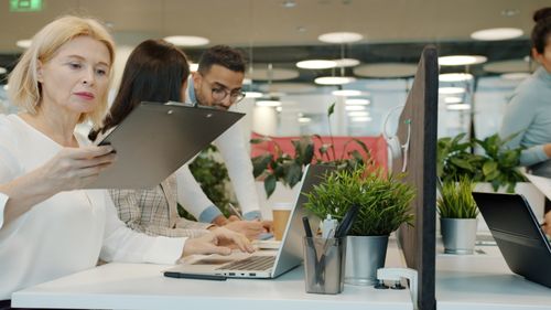 Free Group of professionals working together in a modern office setting. Stock Photo