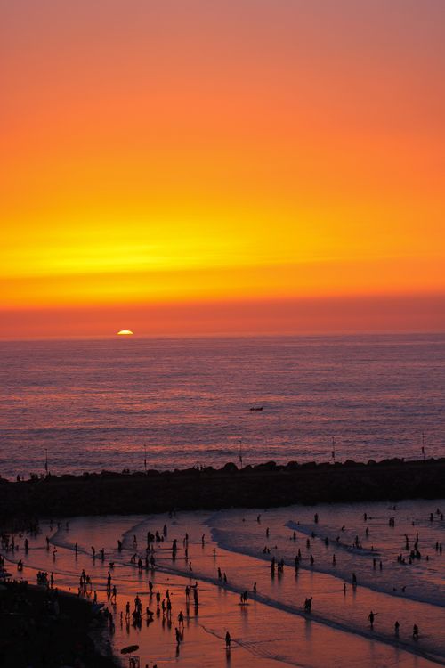 Free A mesmerizing sunset view over Rabat beach with people enjoying the sea. Stock Photo