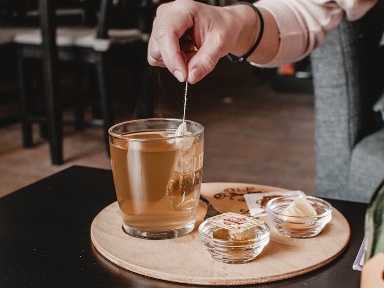 A Person Holding A Teabag