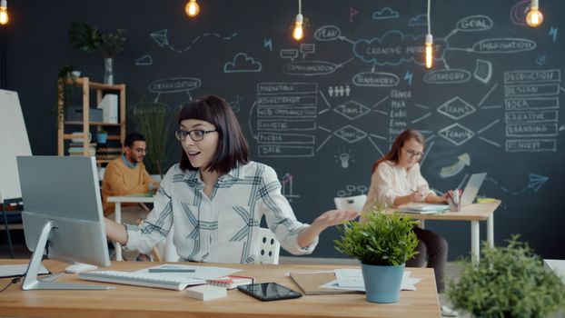 Creative team brainstorming in modern office with chalkboard wall and plants. Vibrant and dynamic environment.