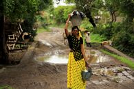 A Woman Carrying a Basin