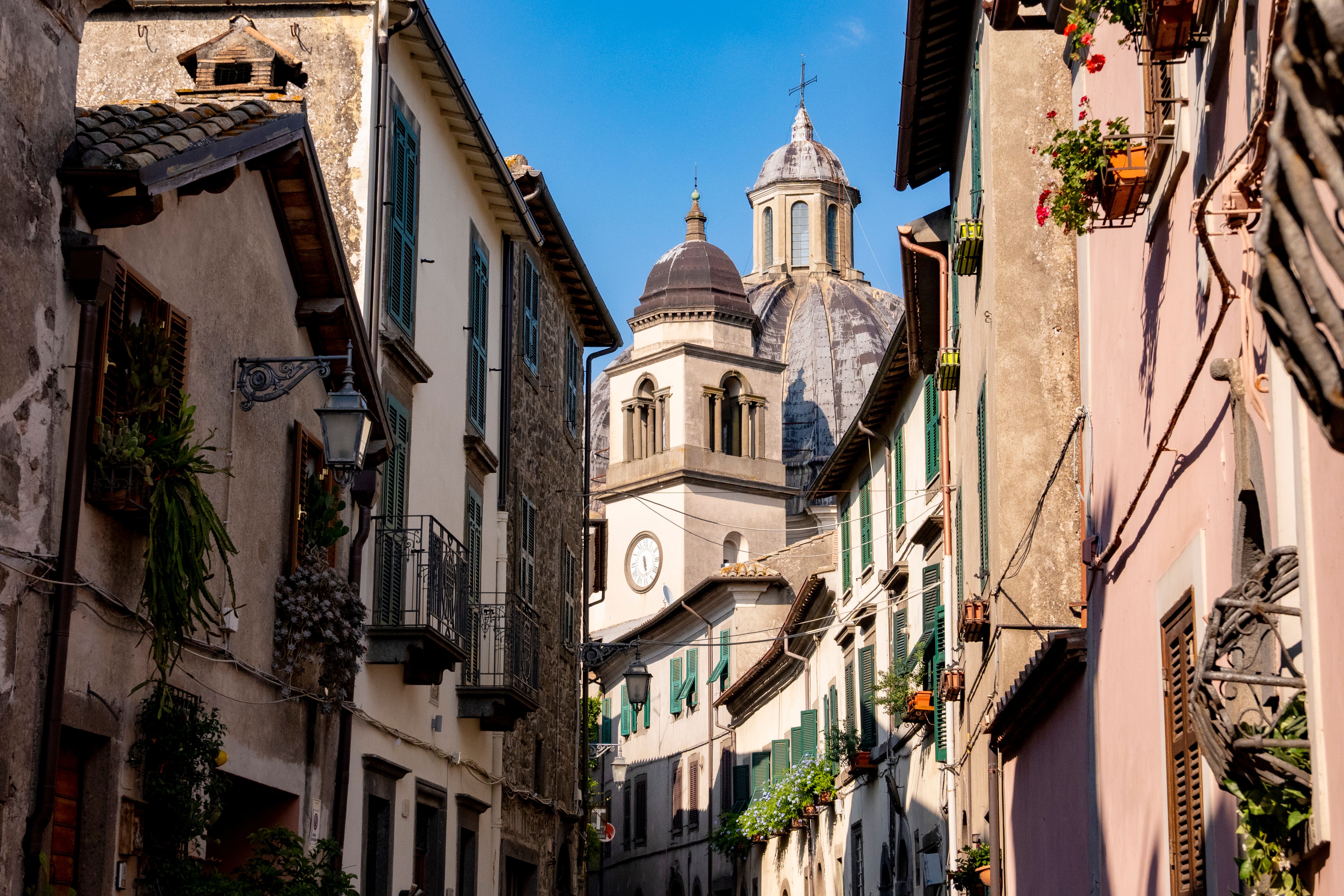 Explore the charming historic streets of Montefiascone, Italy, featuring iconic architecture bathed in daylight.