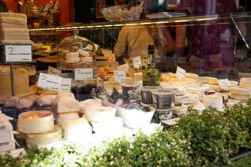 Free A wide selection of artisanal cheeses on display in a cozy French market. Stock Photo