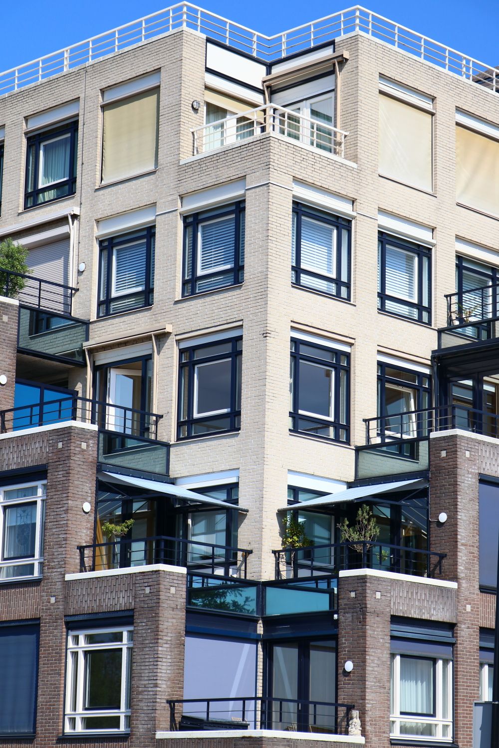Urban apartment building with glass balconies, Rosy Fields on Pexels