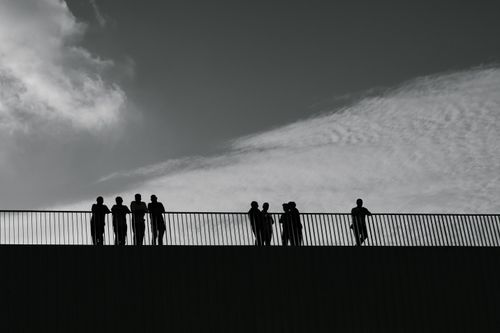 Free Artistic black and white silhouettes of people on a bridge against the sky in İstanbul, Türkiye. Stock Photo