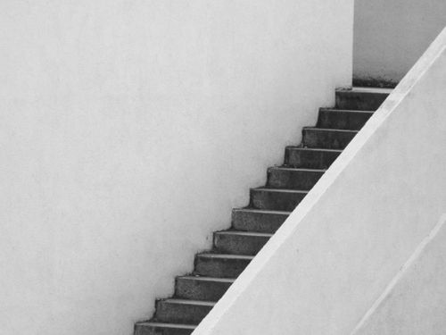 Free Black and white image of a minimalist staircase in an urban setting, showcasing architectural simplicity. Stock Photo