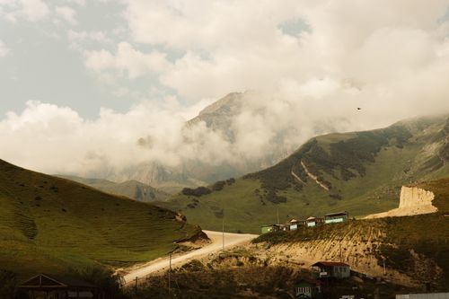 Free Breathtaking view of Laza's mountainous terrain with scattered clouds and quaint houses. Stock Photo