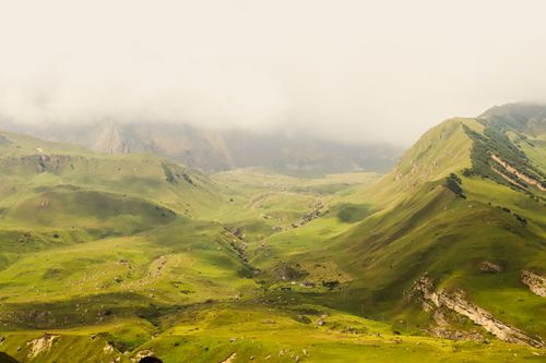 Free Breathtaking landscape of rolling green mountains in Laza, Azerbaijan, shrouded by mist and clouds. Stock Photo