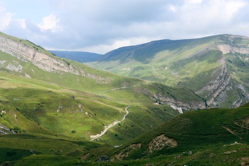 Free Breathtaking view of rolling green mountains in Laza, Azerbaijan with a clear sky. Stock Photo