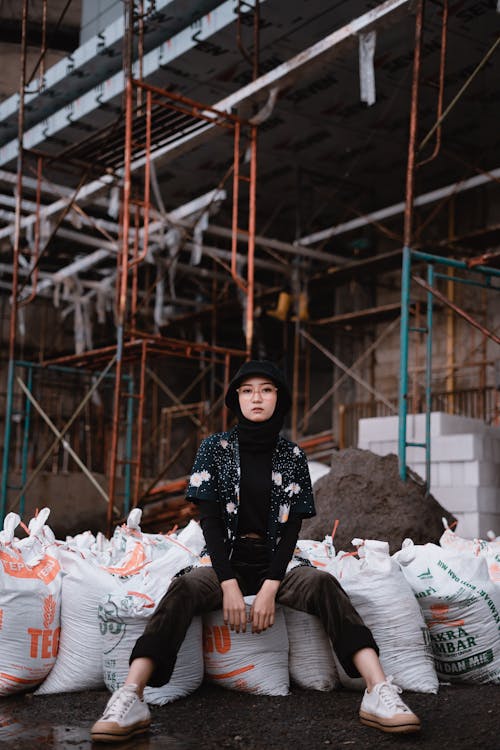 Free Photo Of Woman Sitting On Sacks Stock Photo