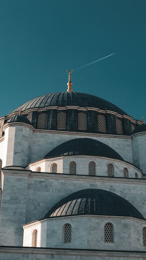 Free Detailed view of a mosque's domes against a clear blue sky in Ankara, reflecting Ottoman architecture. Stock Photo
