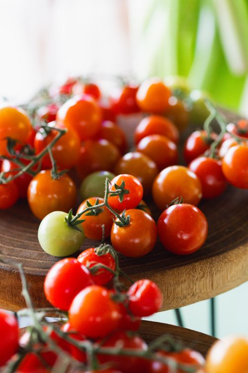 Free Vibrant cherry tomatoes on rustic wood, ideal for healthy lifestyle themes. Stock Photo