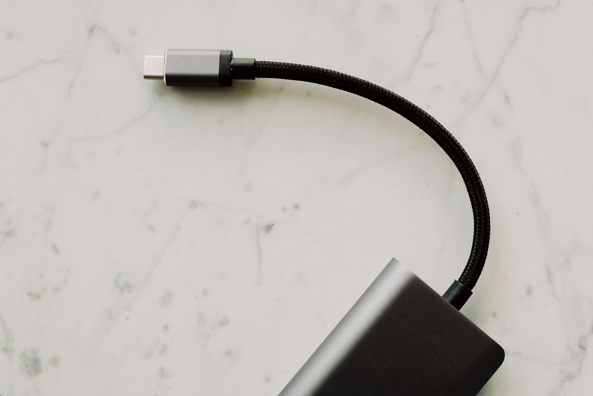 High-quality USB-C cable with connector displayed on elegant marble background for tech enthusiasts.