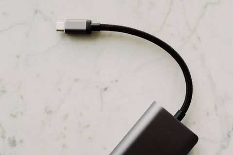 Black braided USB-C cable on marble