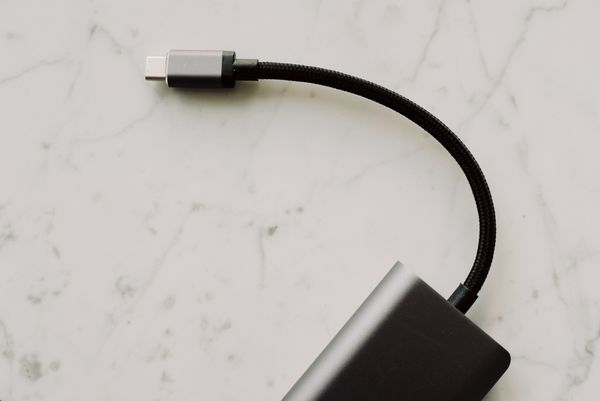 Braided USB-C lead on a pale marble surface, photo by ready made on Pexels