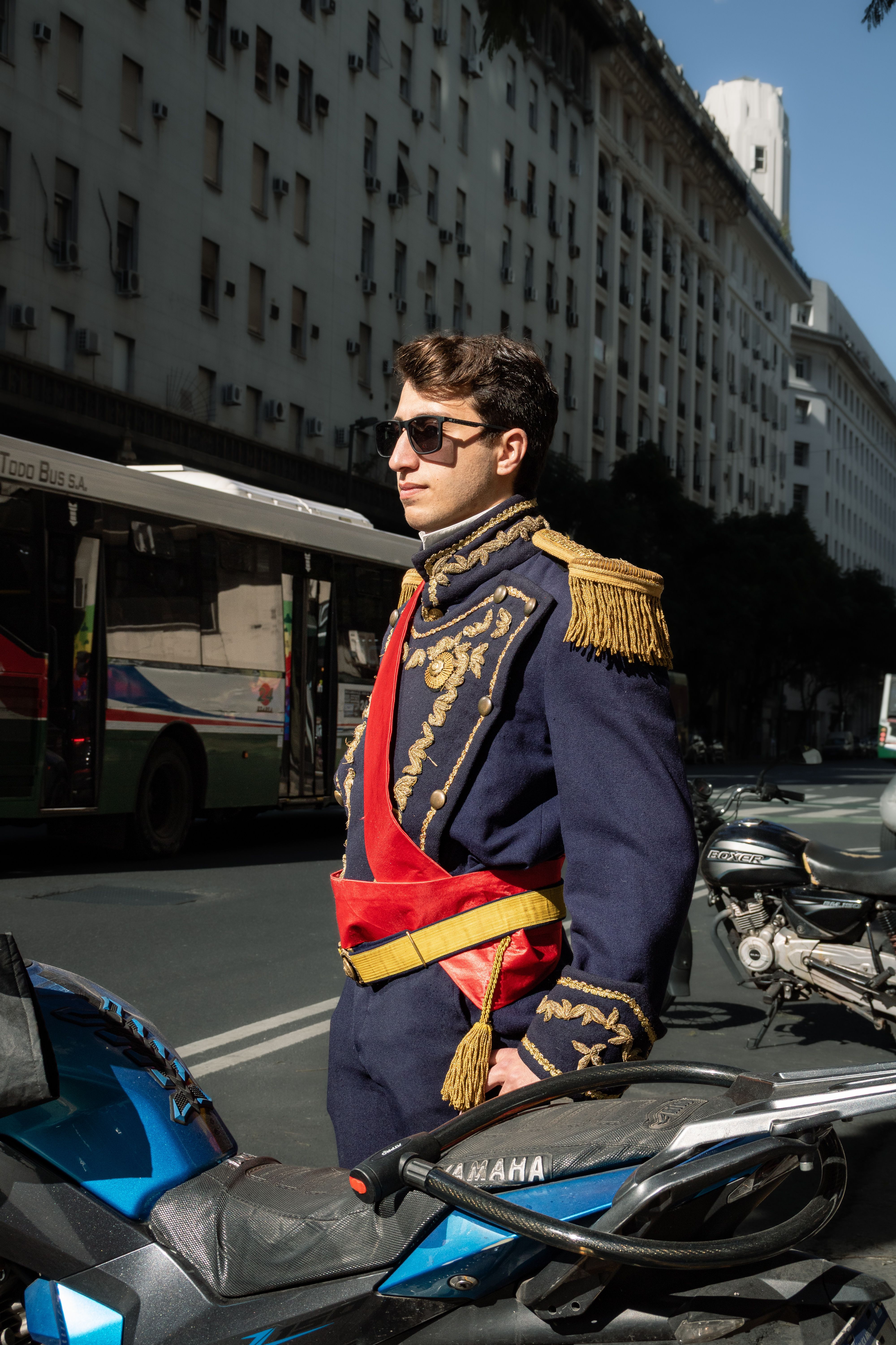 Man in historical military uniform on a sunny Buenos Aires street.