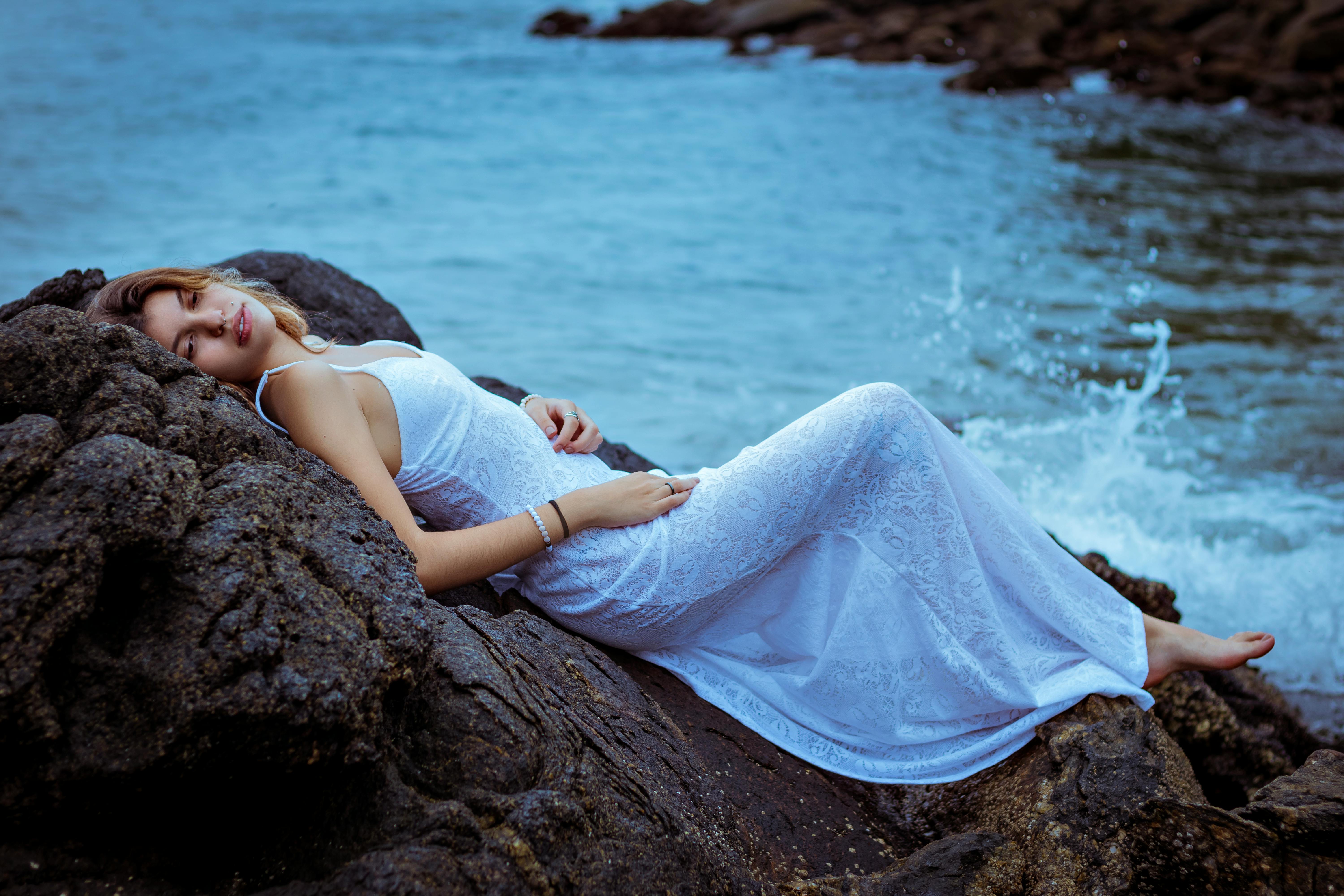 Photo of Woman Lying On Rock · Free Stock Photo