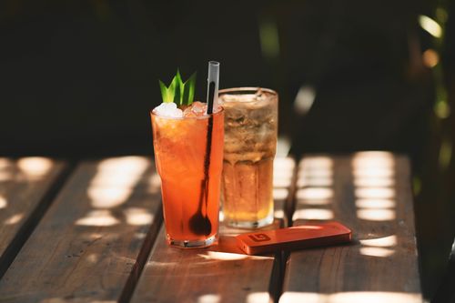 Free Two refreshing cocktails on a sunlit wooden table, perfect for summer relaxation. Stock Photo