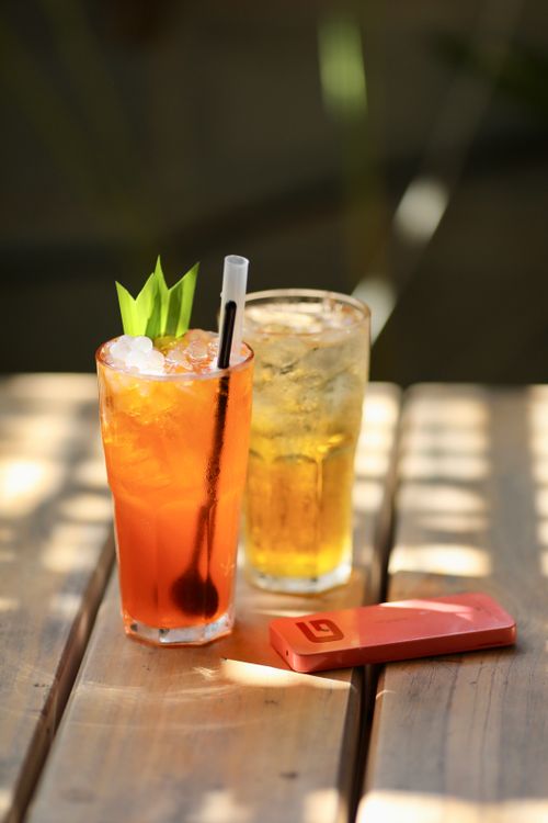 Free Chilled refreshing cocktails on a sunny wooden table, perfect for summer relaxation. Stock Photo