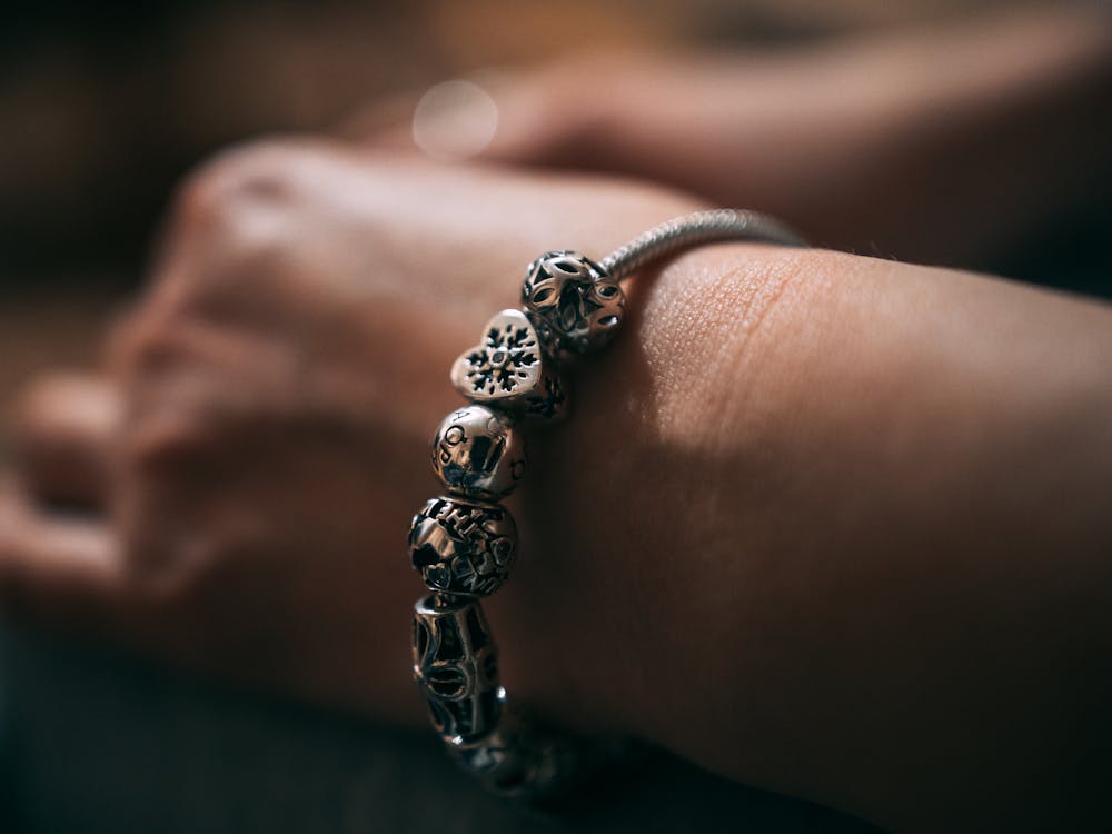 Close-Up Photo of Silver Charm Bracelet