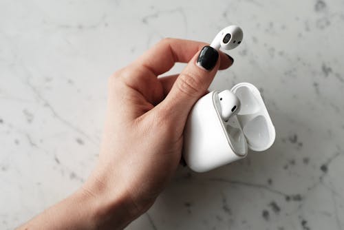 Free Photo of Person Holding Apple Airpods Stock Photo
