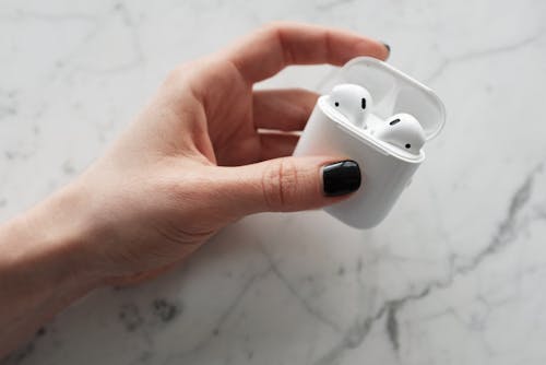 Person Holding White Apple Airpods