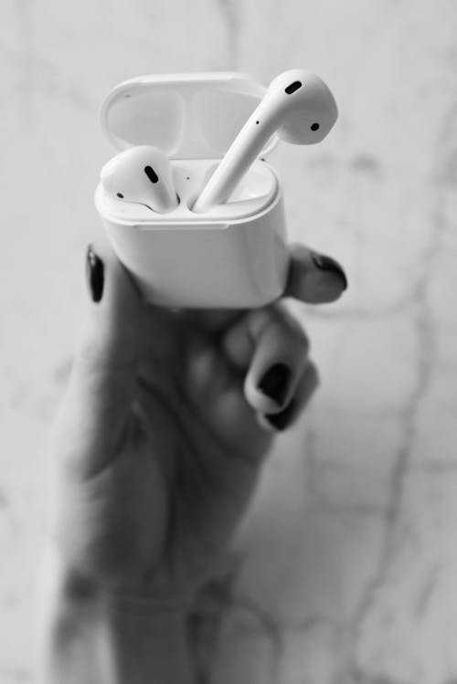 Close-Up Photo of Person Holding Apple Airpods