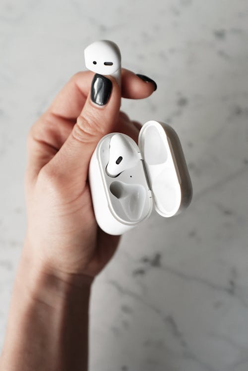 Free Photo of Person Holding Apple Airpods Stock Photo