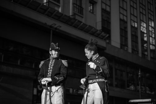 Free Two uniformed guards in historic attire engage in discussion on a Buenos Aires street. Stock Photo