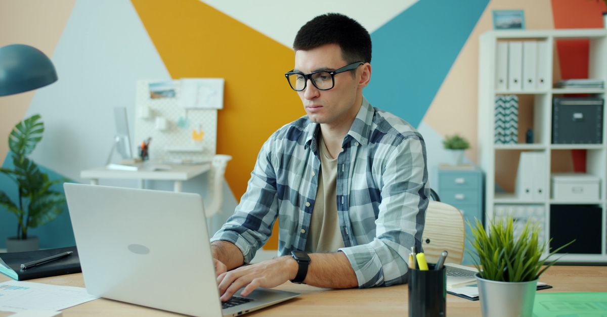 A person reviewing an email on a laptop