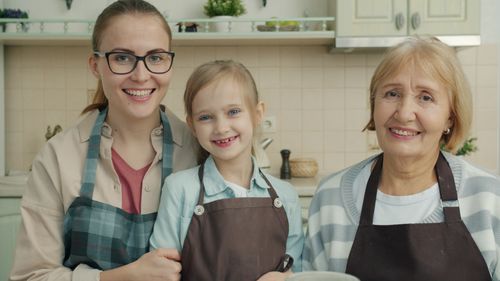 Free Happy family portrait of three generations cooking together. Stock Photo