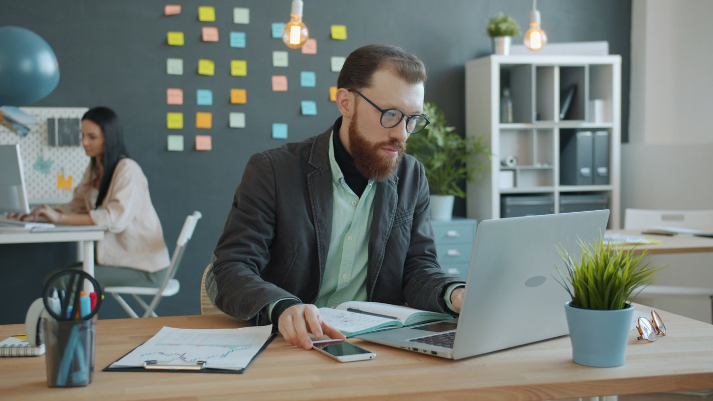 Small business team working together with laptops in a modern office