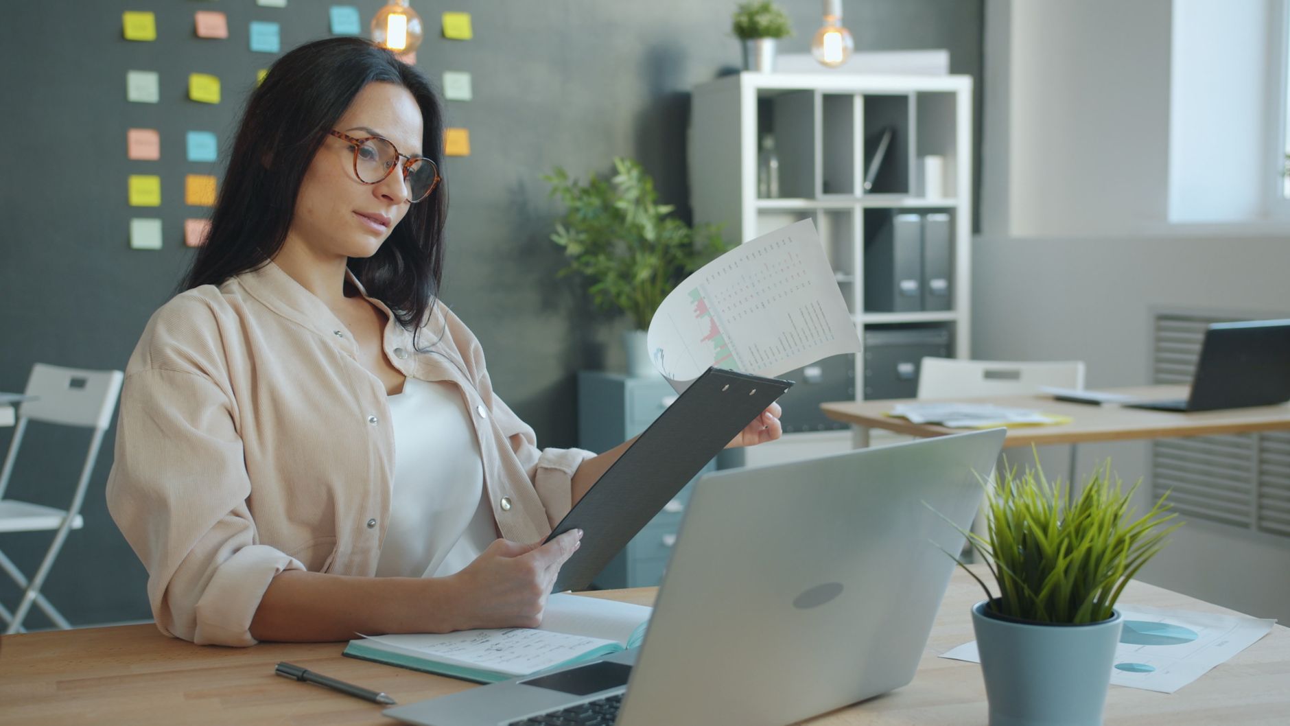 Person researching a company on a laptop, checking government databases and job postings