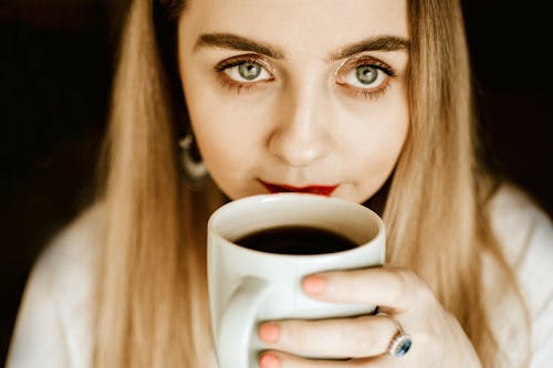 Photo of Woman Holding Coffee Cup