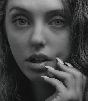 Close-up black and white portrait of a woman in Kyiv, focusing on facial expression and beauty.