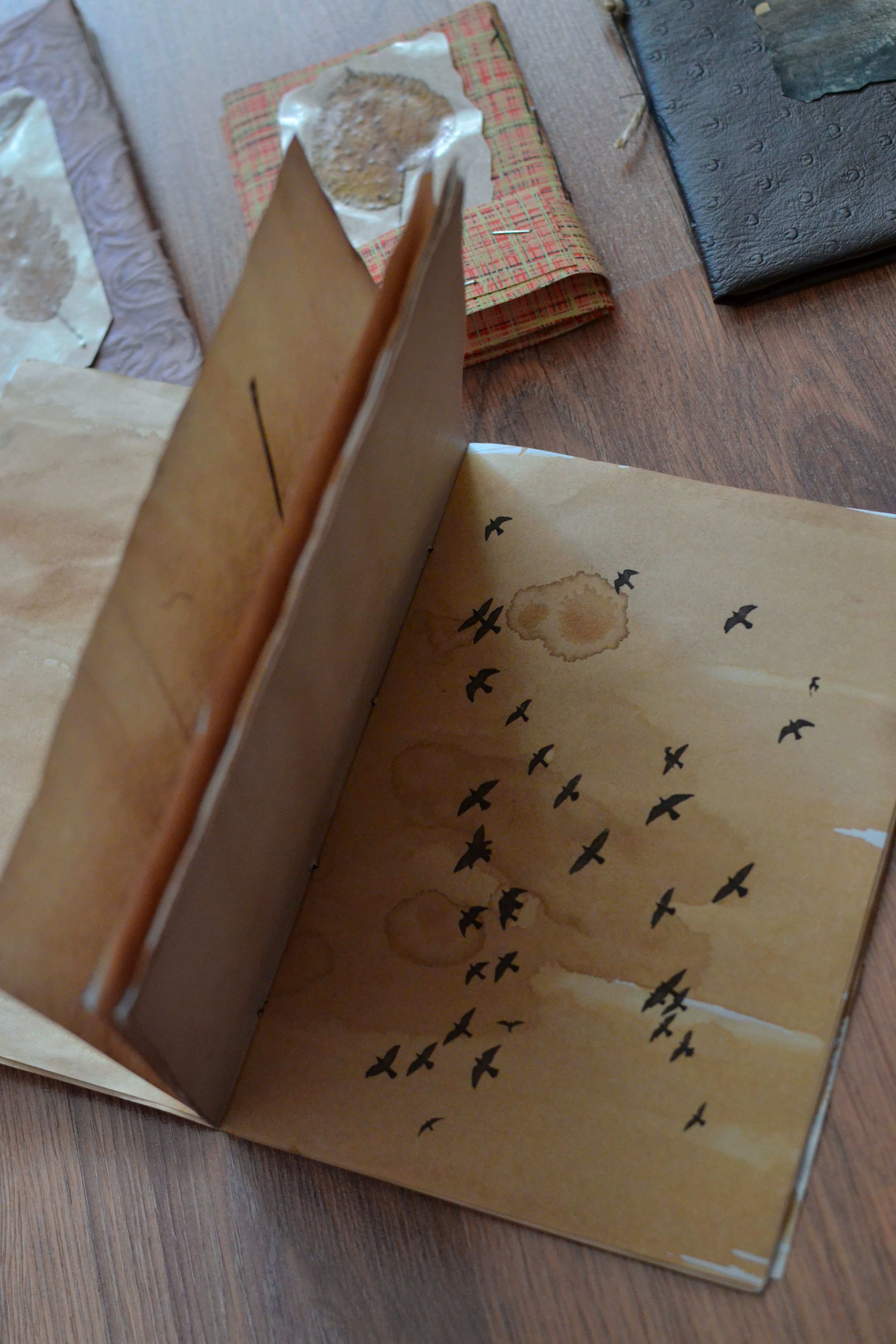 Open rustic journal with bird sketch on aged pages, evoking nostalgia.