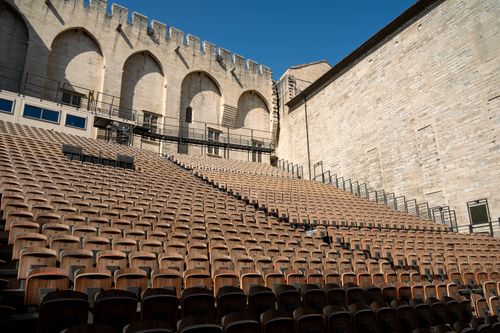 Free Rows of wooden seats in an empty outdoor theater under blue sky in Avignon, France. Stock Photo