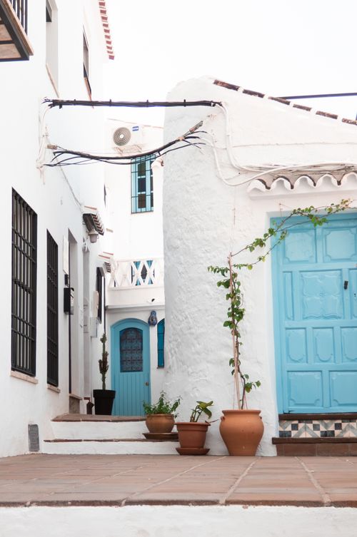 Free Discover the picturesque whitewashed architecture of Frigiliana, Spain, with vibrant blue doors. Stock Photo