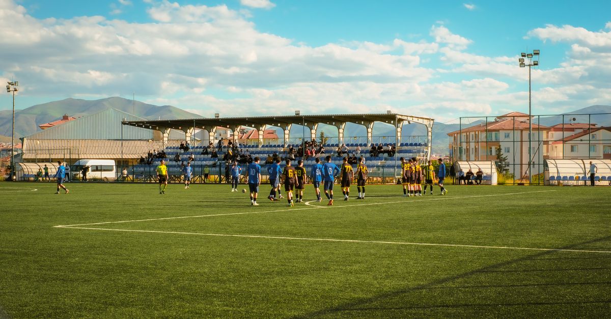 An outdoor soccer game with teams playing on a grass field in Malatya, Türkiye.