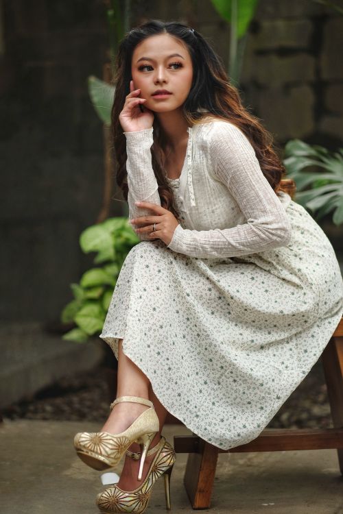 Free Woman in a floral dress posing stylishly outdoors in Bandung. Stock Photo