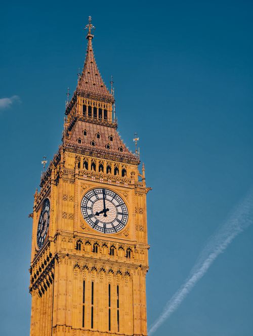 Free Close-up of the famous Big Ben clock tower under a clear blue sky in London, UK. Stock Photo