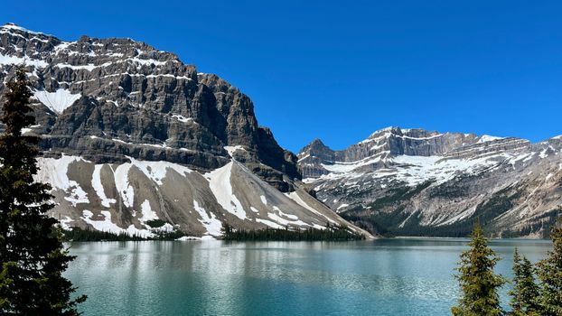 Scenic view of Bow Lake with rugged mountains in Banff National Park, Alberta, Canada.