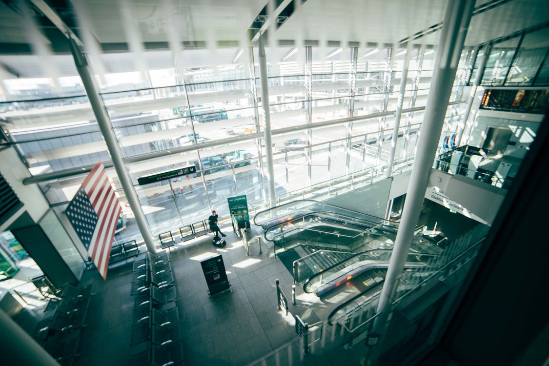 Bright, spacious airport terminal with glass walls, representing travel rewards earned with a credit card