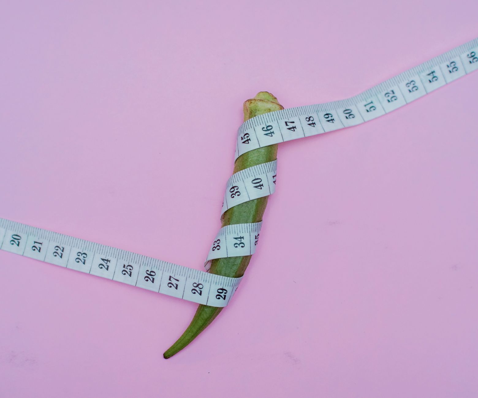Healthy meal prep containers next to a measuring tape, symbolizing diet and weight loss