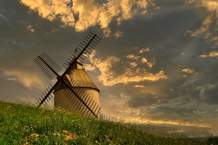 Windmill On Green Grass Field 