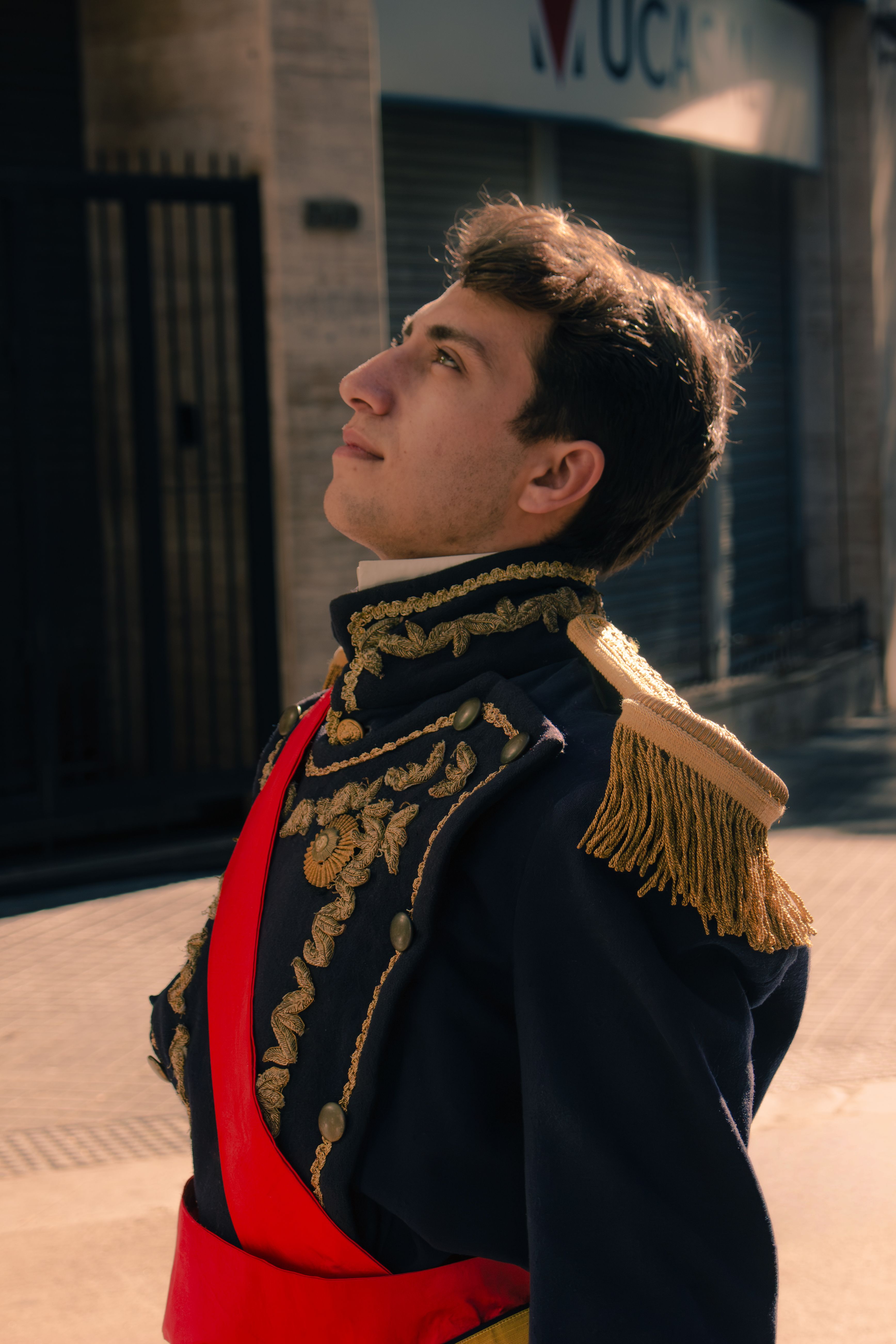 Man in ornate military uniform poses outdoors in Buenos Aires.